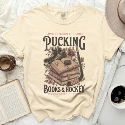 Cream t-shirt with "Pucking Books & Hockey My Favorite Chapter" graphic.
