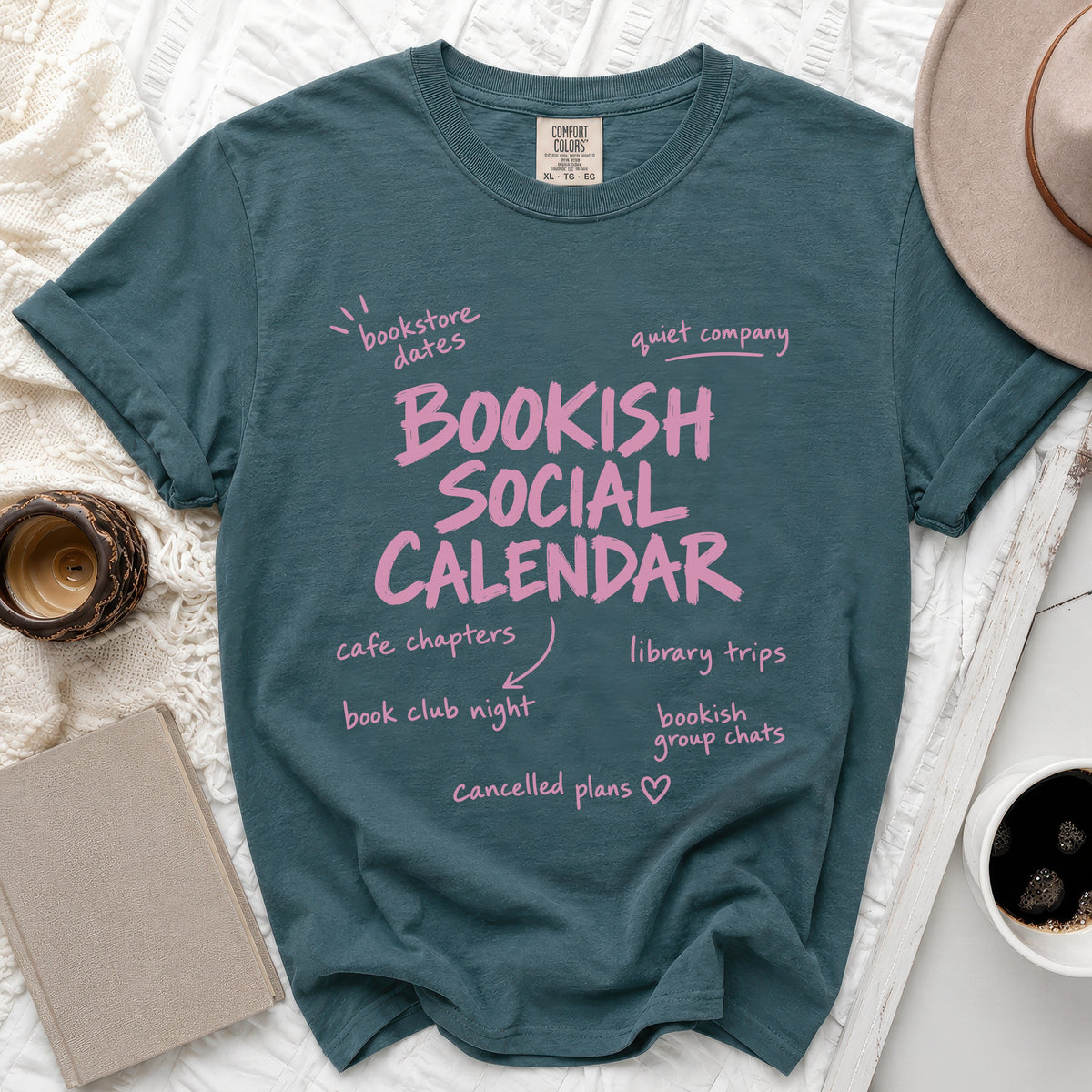 Teal t-shirt with "Bookish Social Calendar" and reading-related activities in pink text.