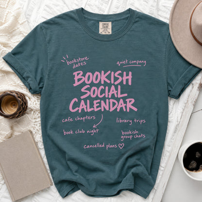 Teal t-shirt with "Bookish Social Calendar" and reading-related activities in pink text.