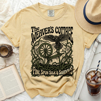Yellow t-shirt with "The Weaver's Cottage" and raven graphic.