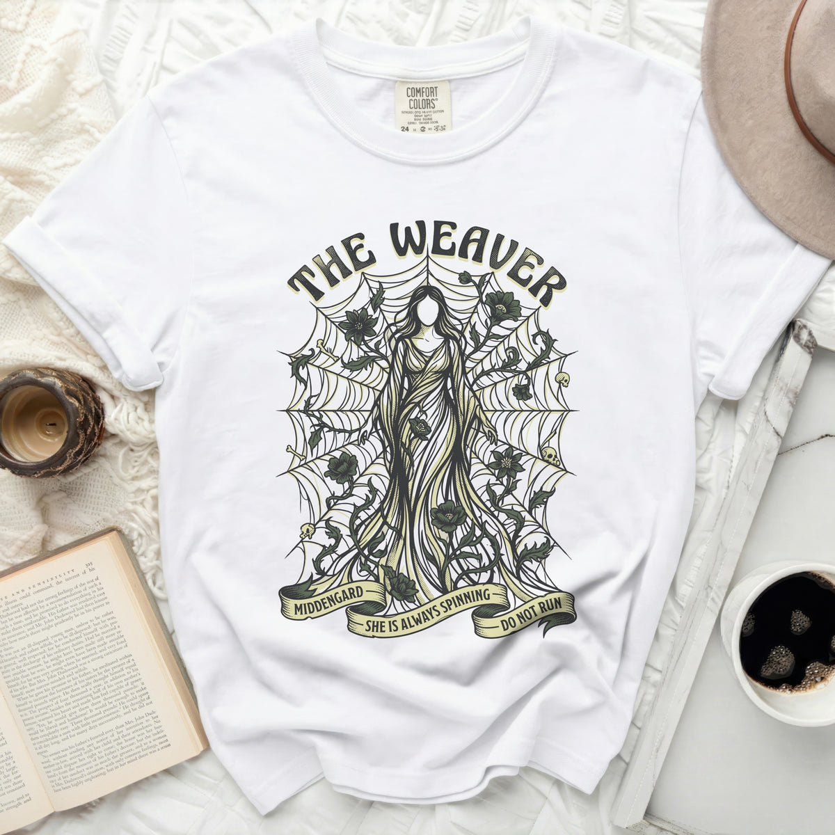 The Weaver shirt with graphic of woman, cobwebs, and text.