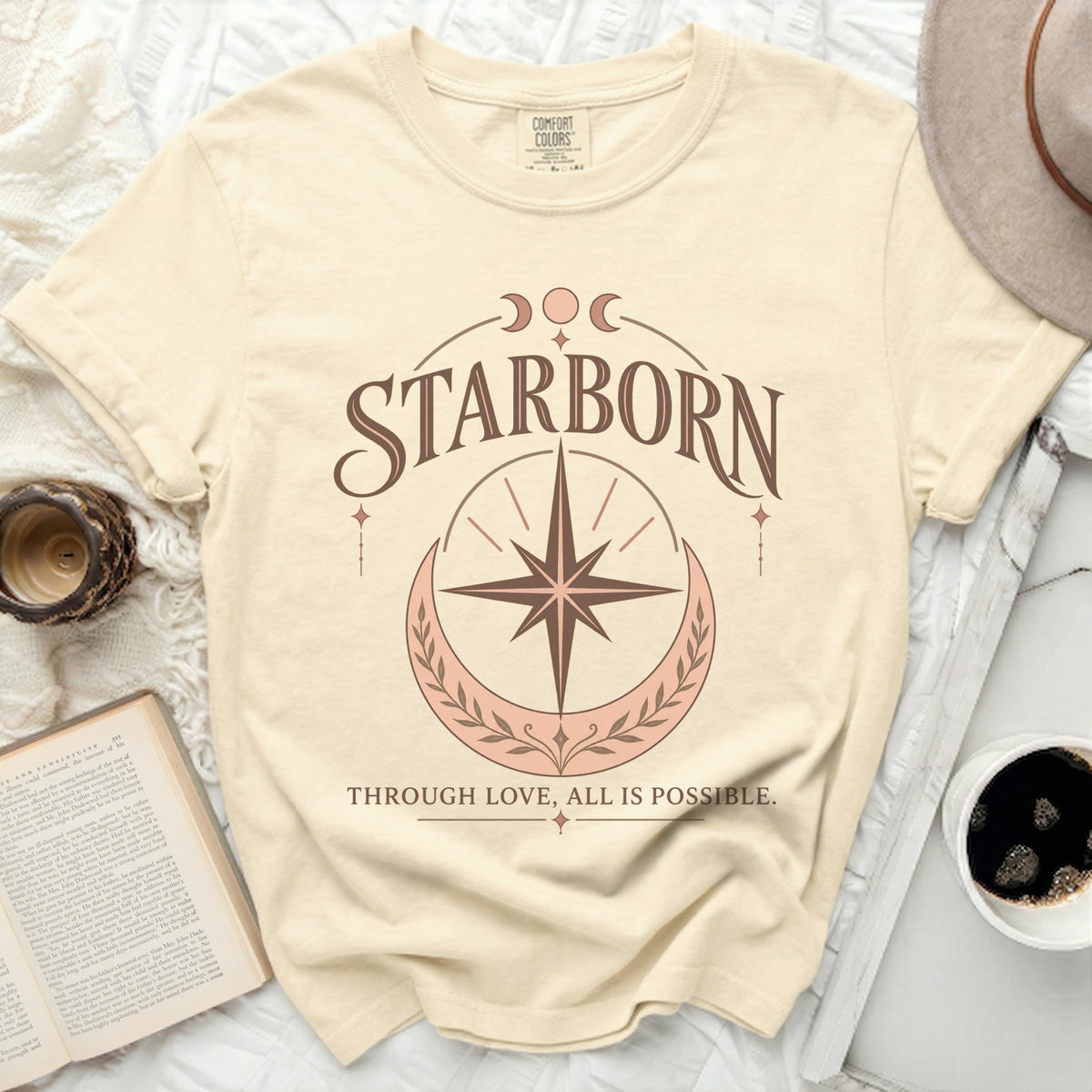 Cream t-shirt with "STARBORN" and "THROUGH LOVE, ALL IS POSSIBLE" text.