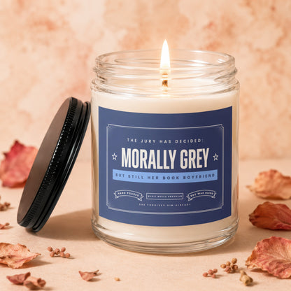 Morally Grey book boyfriend candle with text "The jury has decided" and "She forgives him already".