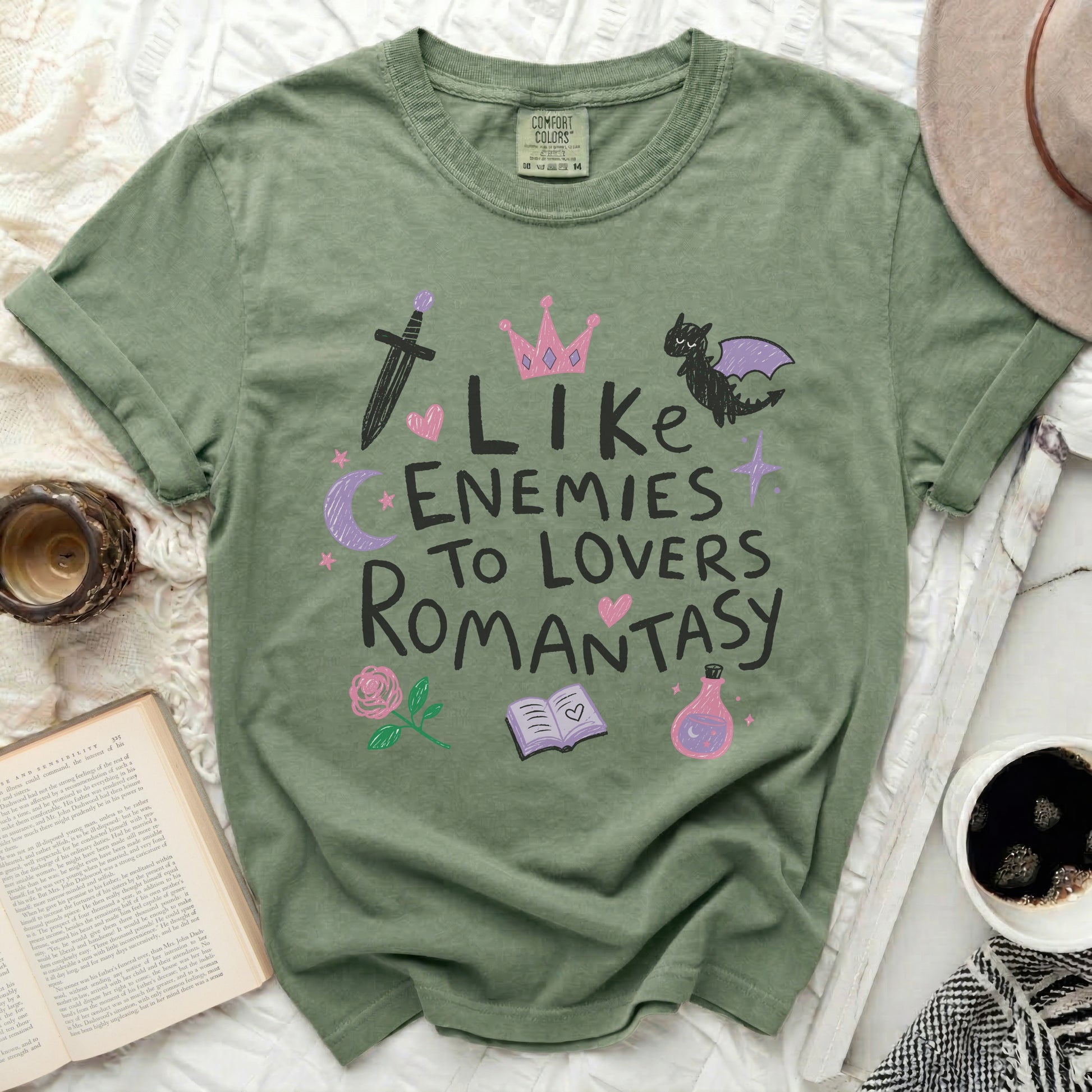 Olive green t-shirt with "Like Enemies To Lovers Romantasy" graphic and icons.