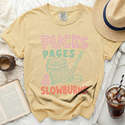 Yellow t-shirt with "Pucks Pages & Slowburn" text and hockey imagery.