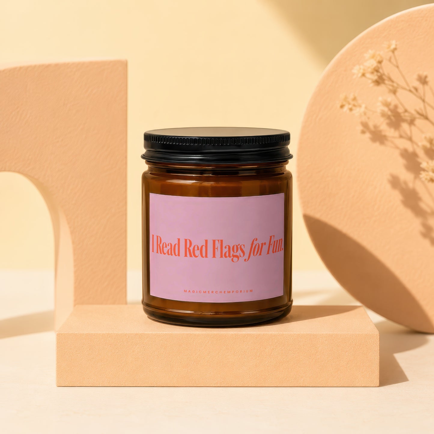Glass jar candle with "I Read Red Flags for Fun" text on a pink label.