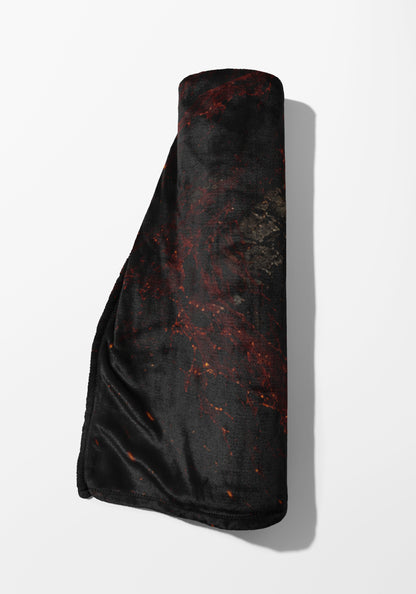 Rolled blanket with black and red marble pattern on white background.