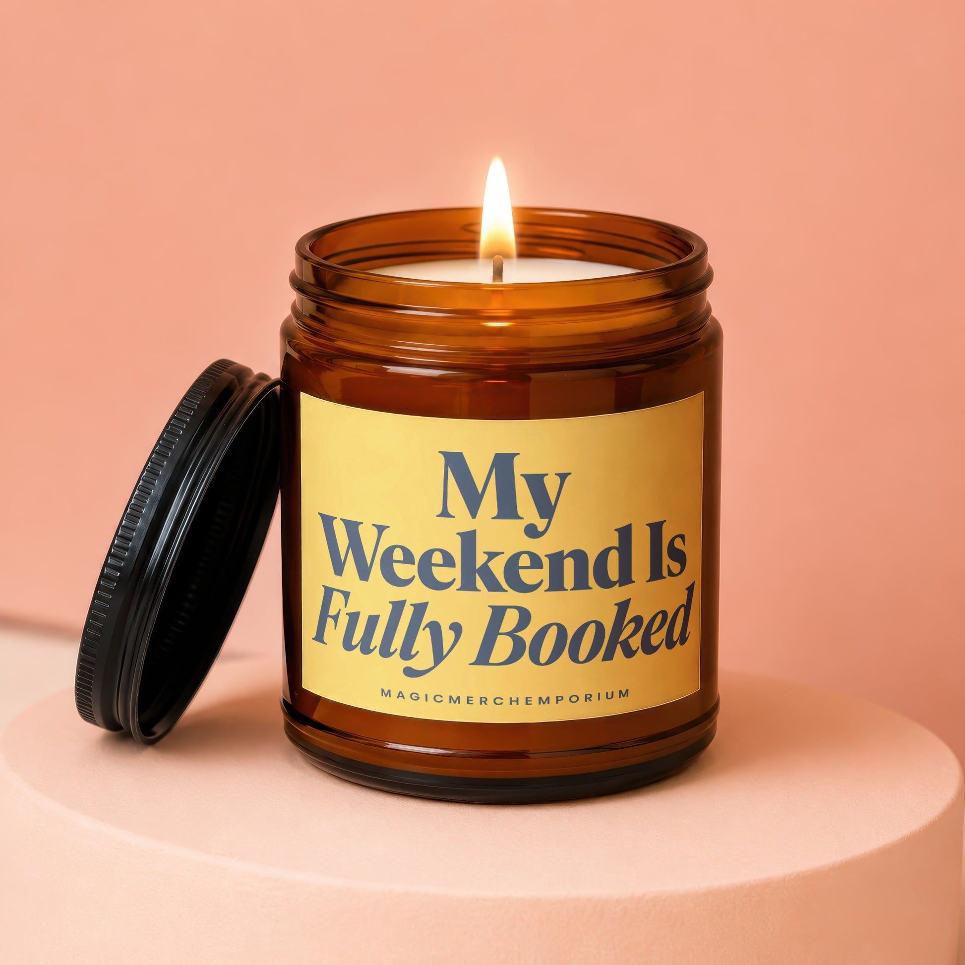 Amber jar candle with lit wick, reads "My Weekend Is Fully Booked".