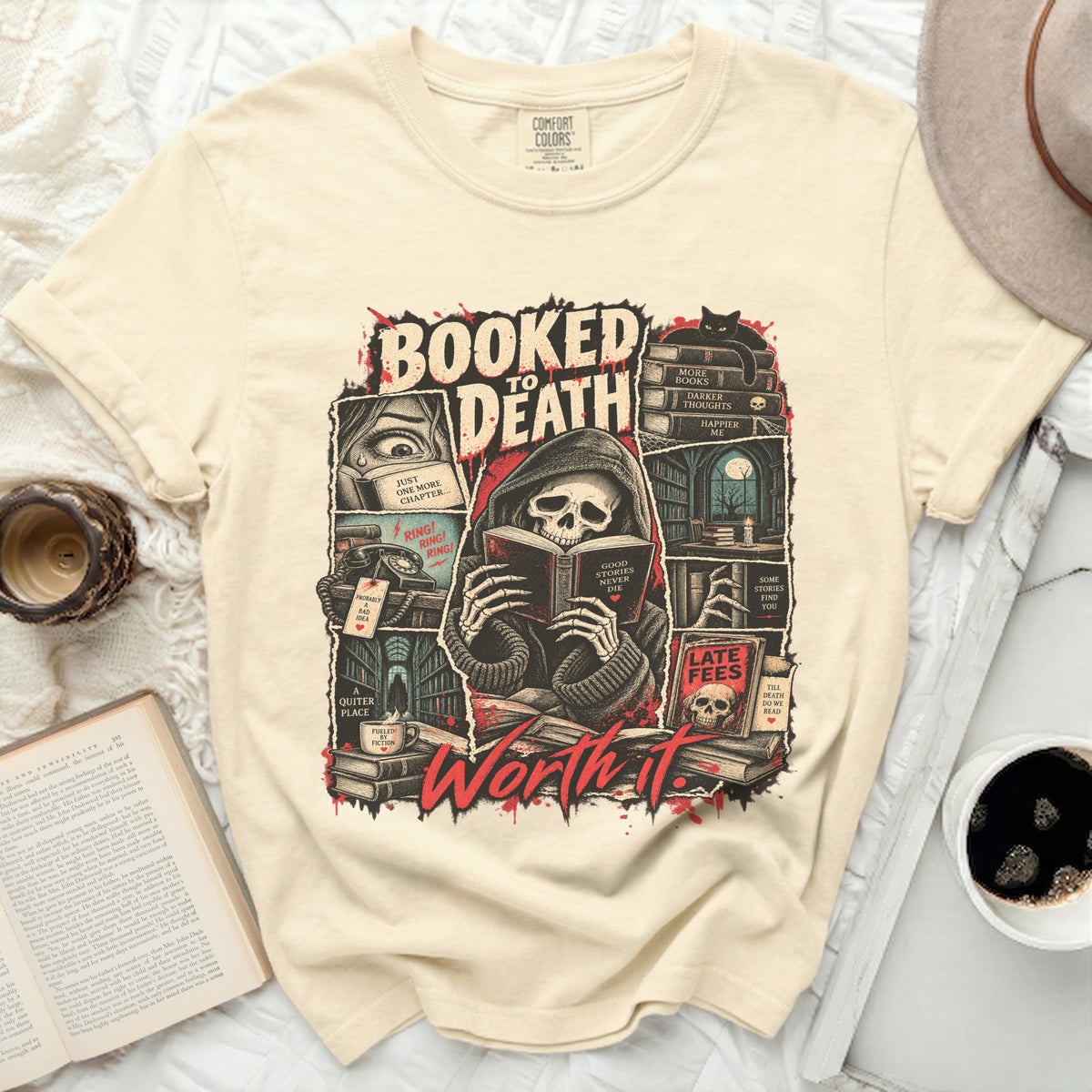 Cream t-shirt graphic featuring grim reaper reading with text "Booked to Death Worth It."