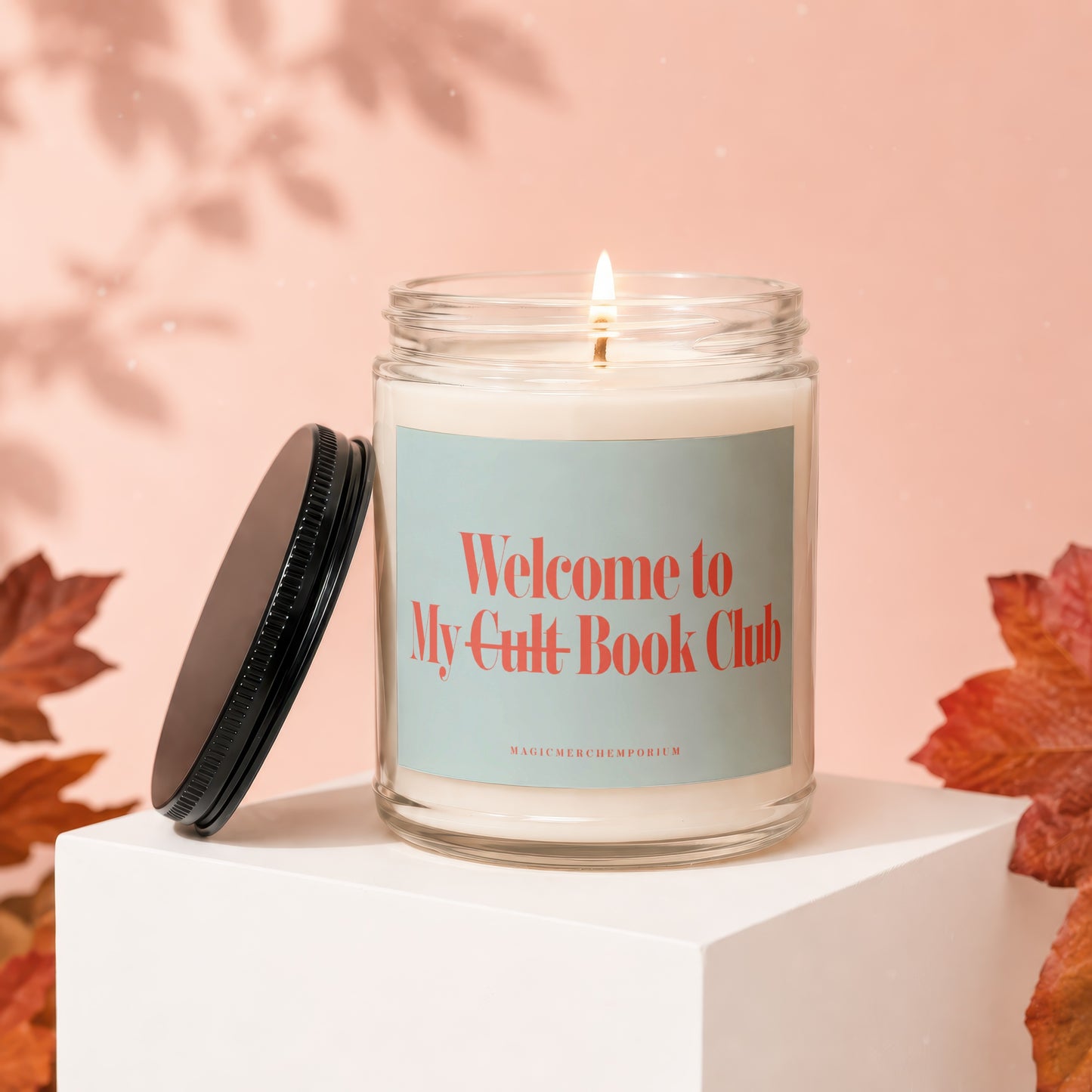Glass candle with lit wick, reads "Welcome to My Cult Book Club".