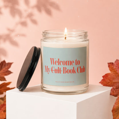 Glass candle with lit wick, reads "Welcome to My Cult Book Club".