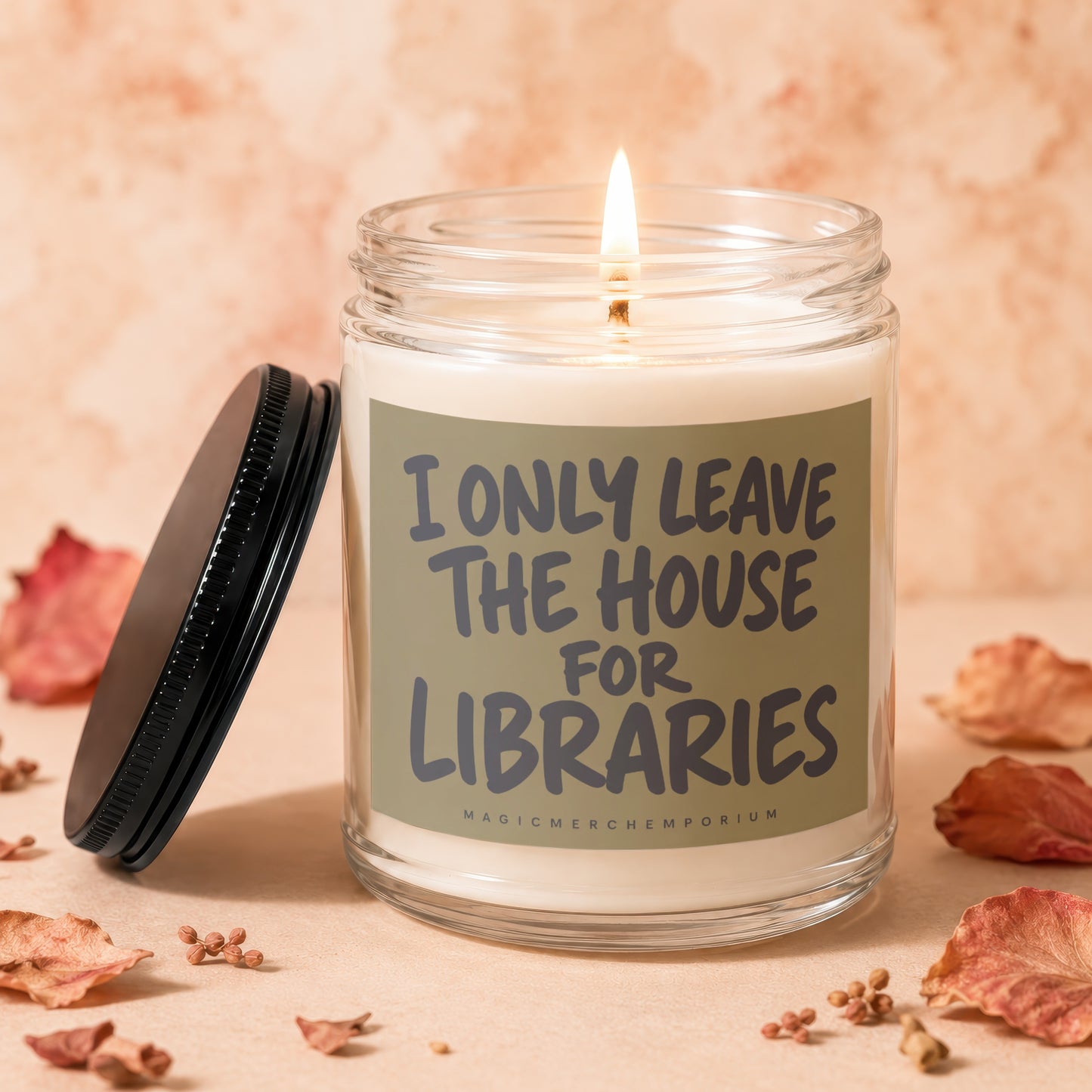 Candle with text "I ONLY LEAVE THE HOUSE FOR LIBRARIES" and "MAGICMERCHEMPORIUM".