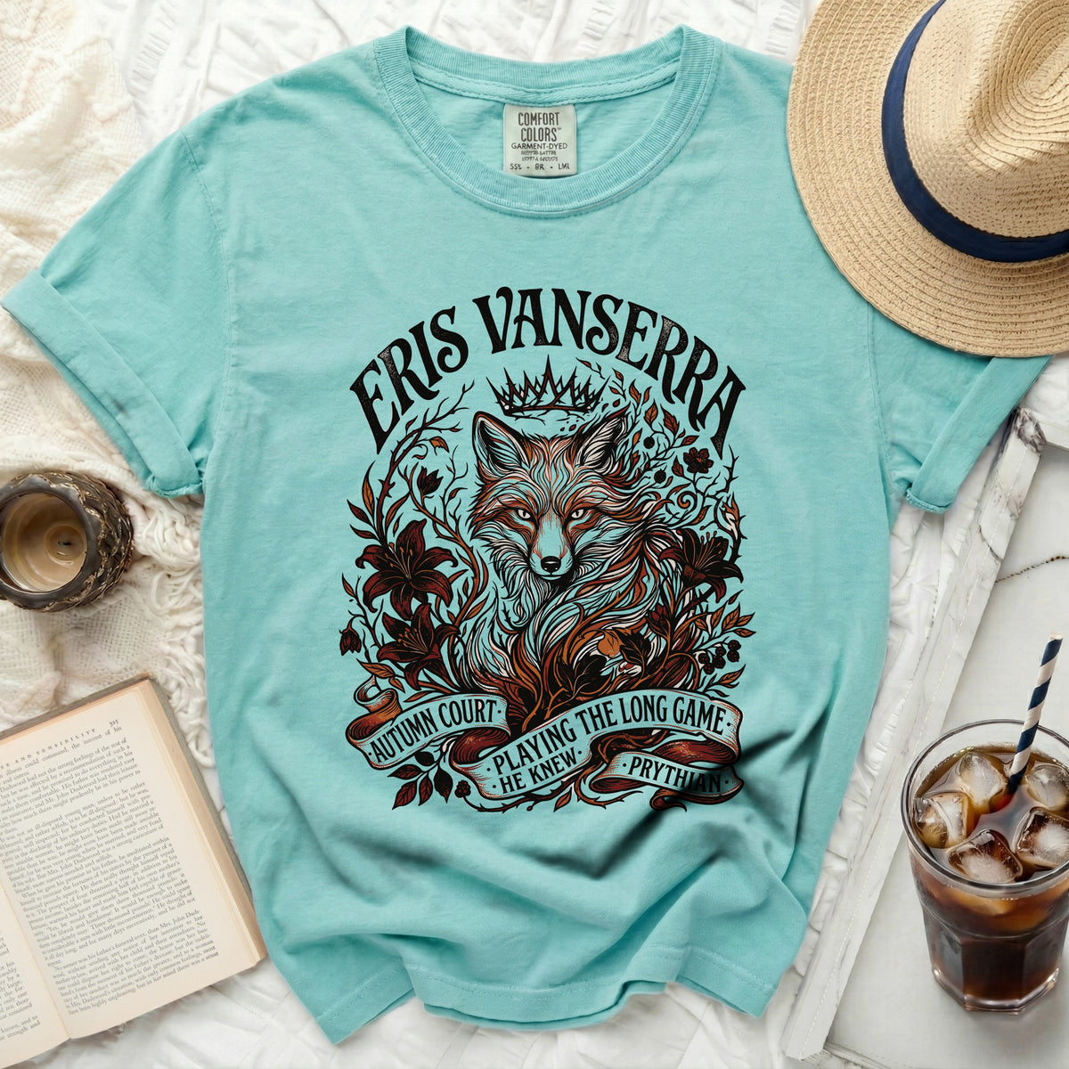 Aqua t-shirt with Eris Vanserra, fox, crown, and ribbon design.