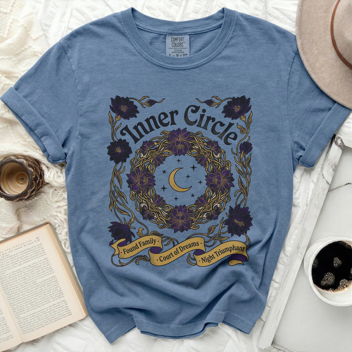 Blue t-shirt with "Inner Circle" text and floral moon wreath graphic.