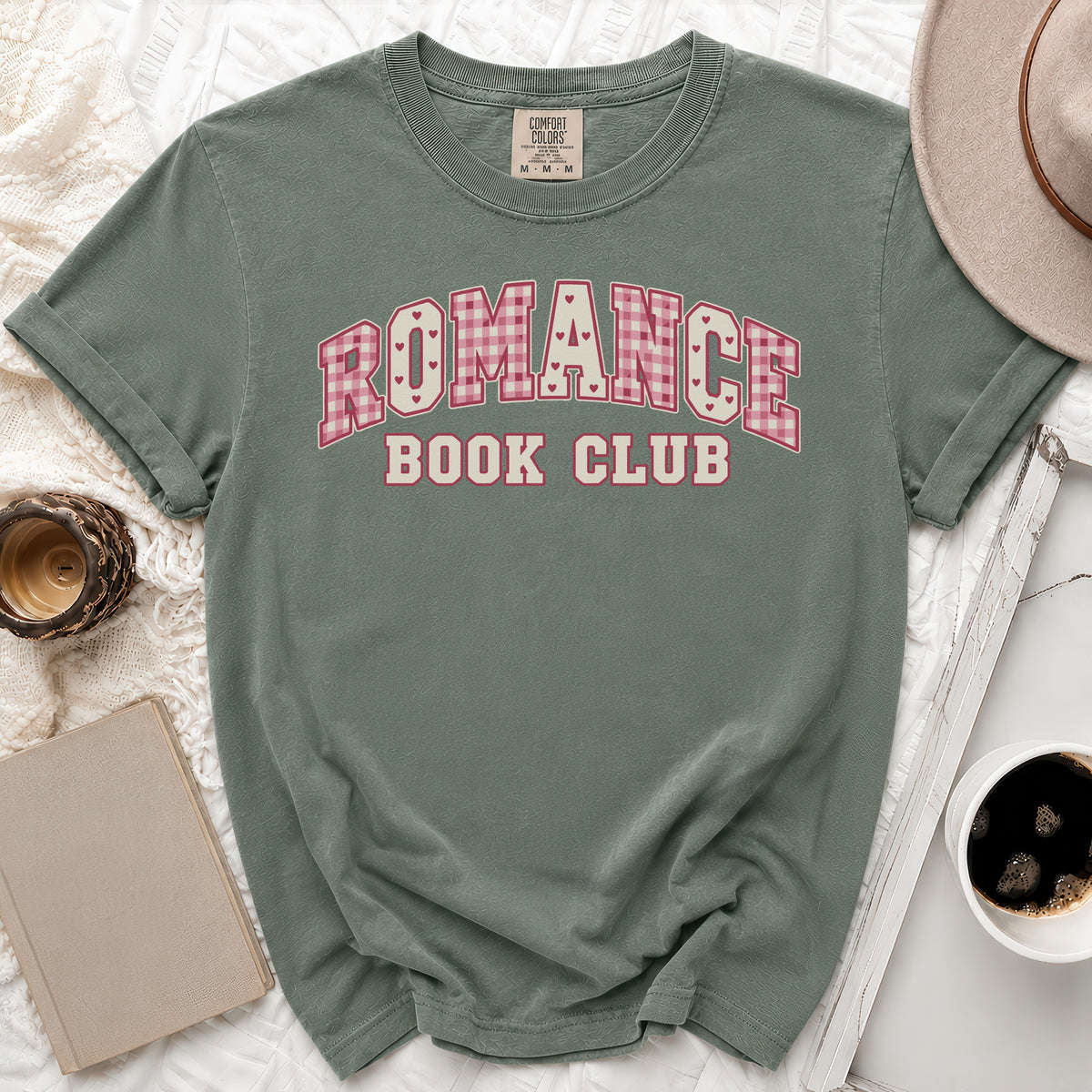Green t-shirt with "Romance Book Club" text in pink plaid and white lettering.