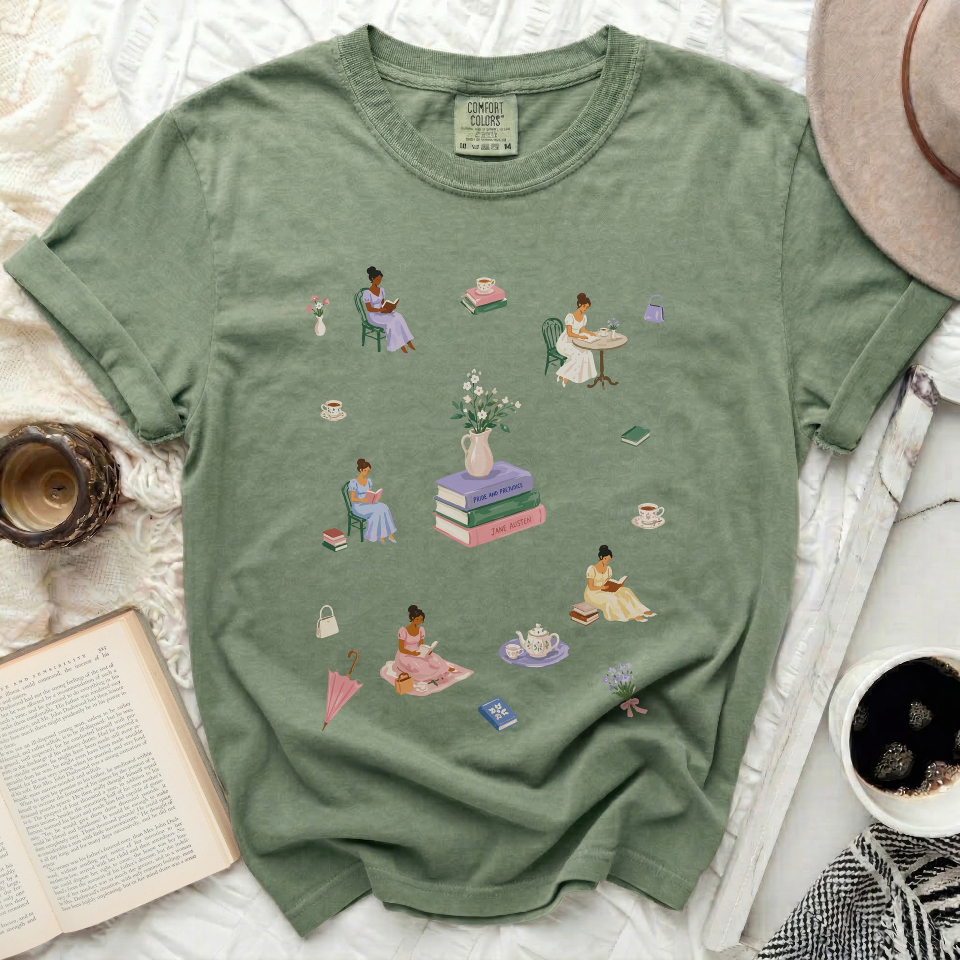 Green t-shirt with print of women reading and drinking tea.
