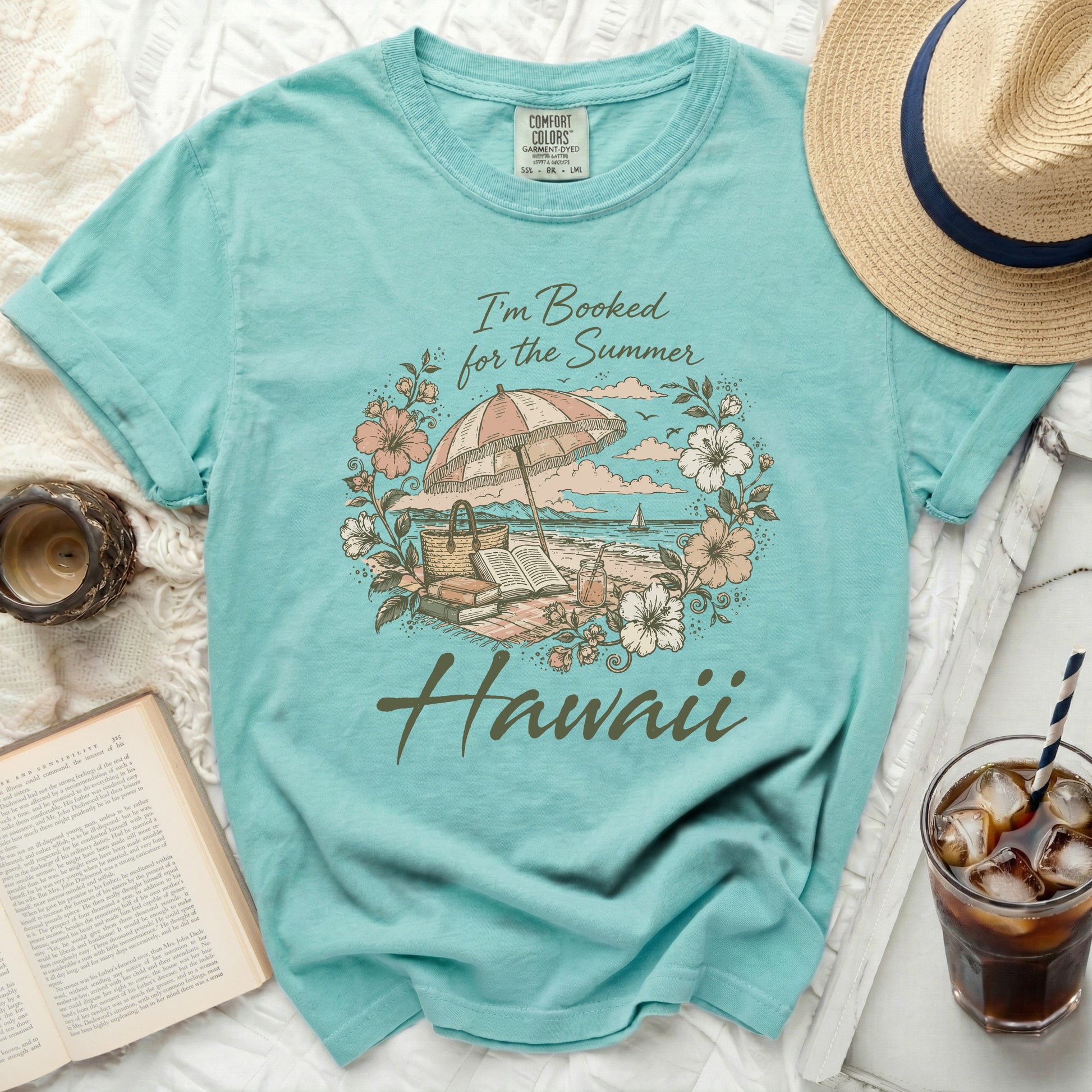 Teal t-shirt with "I'm Booked for the Summer Hawaii" text and beach scene.