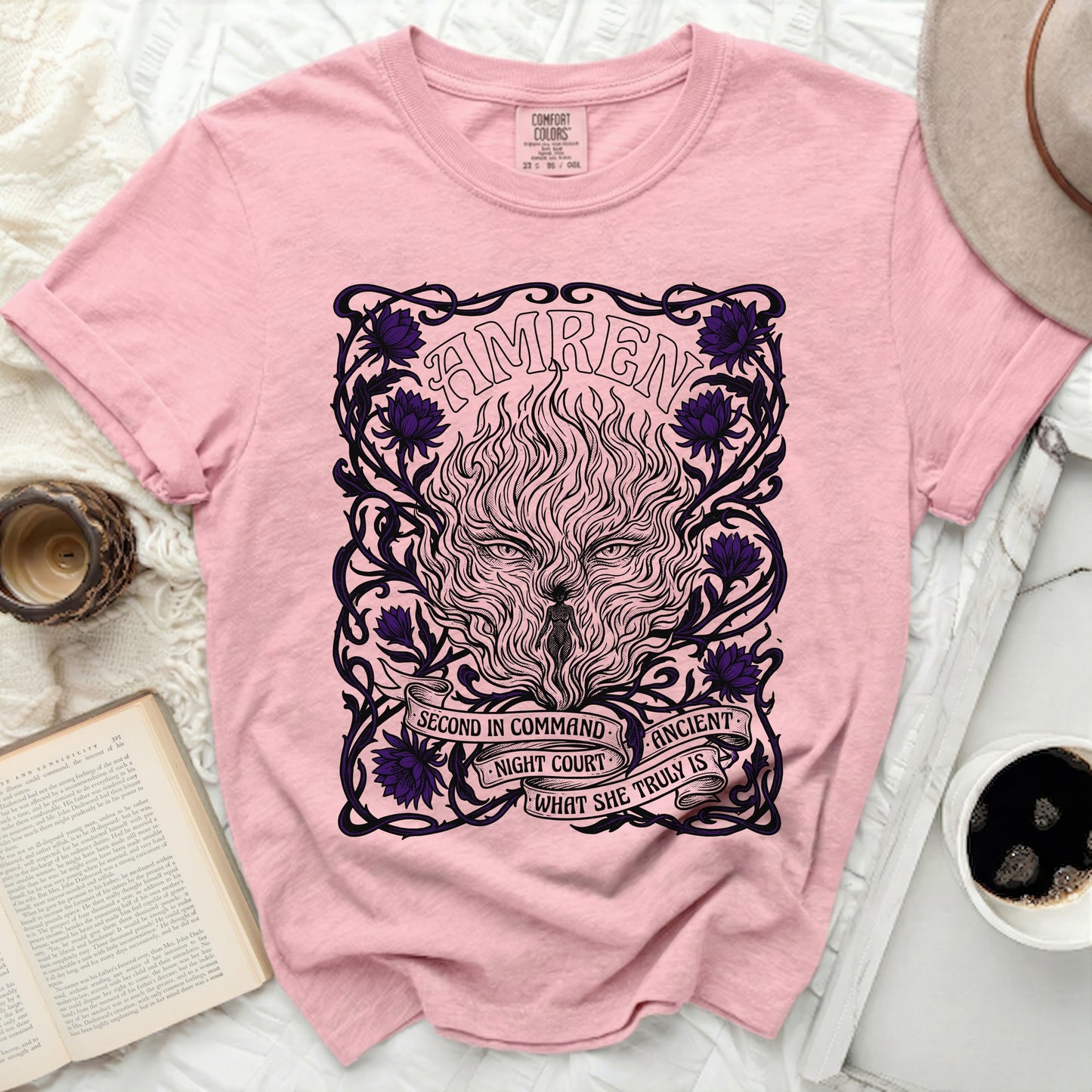Pink t-shirt with "AMREN" text and a fantasy creature design with purple flowers.
