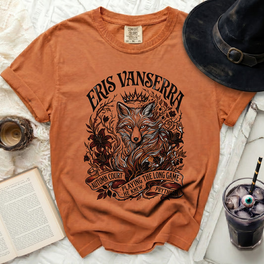 Orange t-shirt with "Eris Vanserra", "Autumn Court", "Playing the long game he knew", and "Prythian" text.