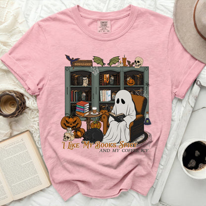 Pink t-shirt with a graphic of a ghost reading, a black cat, pumpkins, and the text "I like my books spicy and my coffee icy".