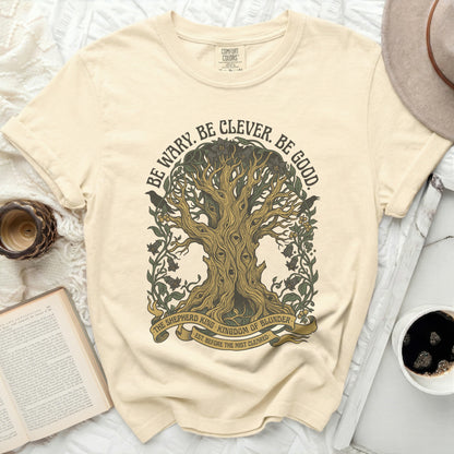 Cream t-shirt with tree graphic and "Be Wary. Be Clever. Be Good." text.