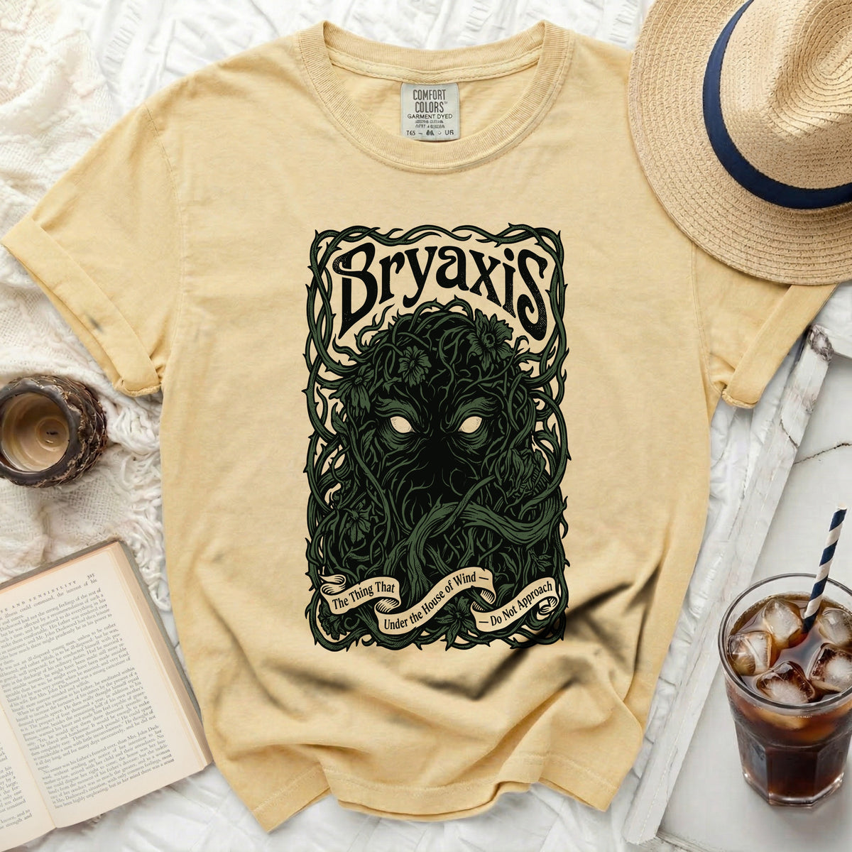 Light yellow t-shirt with "Bryaxis The Thing That Under the House of Wind Do Not Approach" graphic.