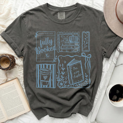 T-shirt with library card design, coffee cup, and book illustrations.