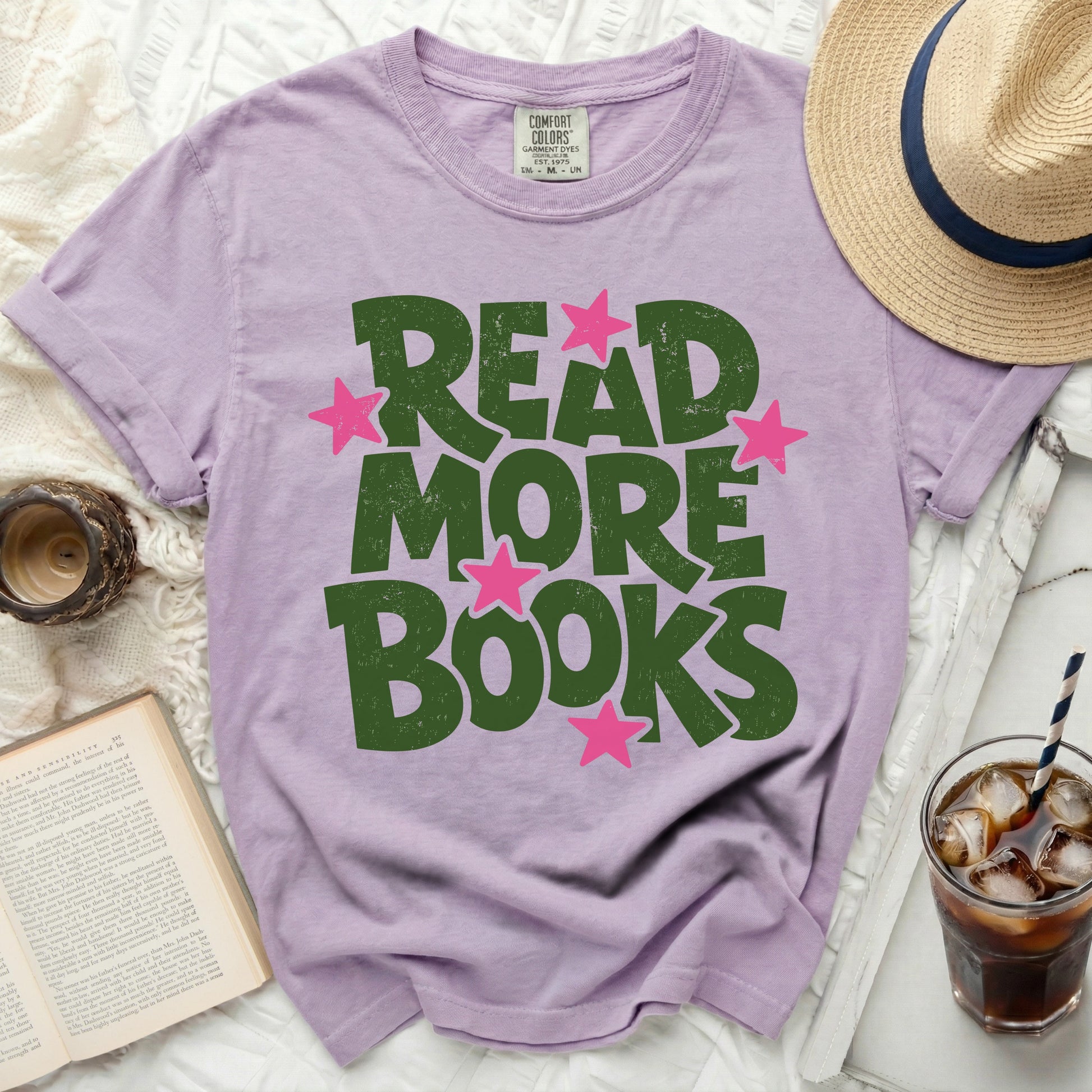 Purple t-shirt with "READ MORE BOOKS" in distressed green letters and pink stars.