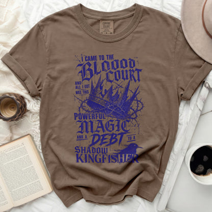 Brown t-shirt with "I came to the Blood Court and all I got was this powerful magic debt" design.
