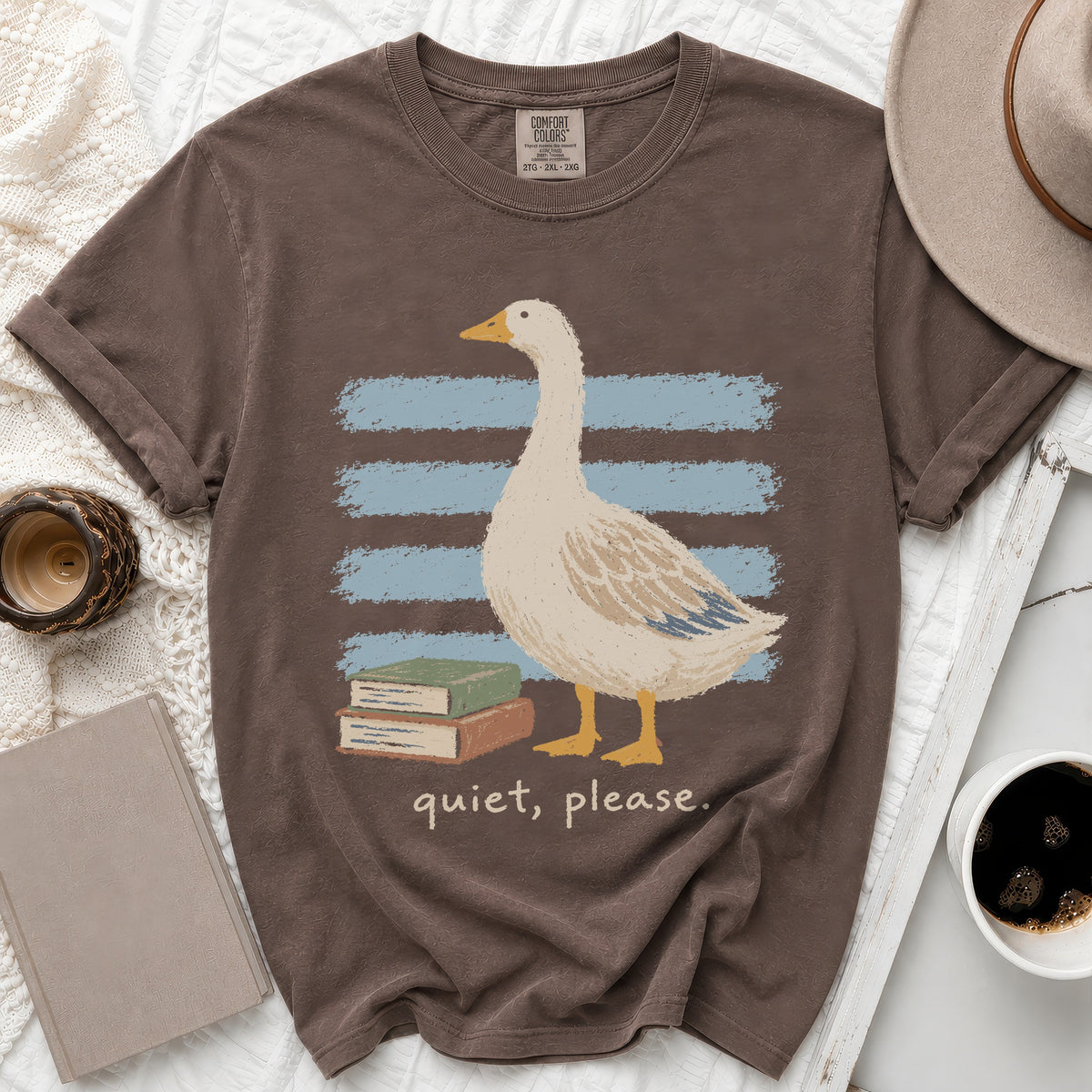 Brown t-shirt with goose, books, and "quiet, please." text.