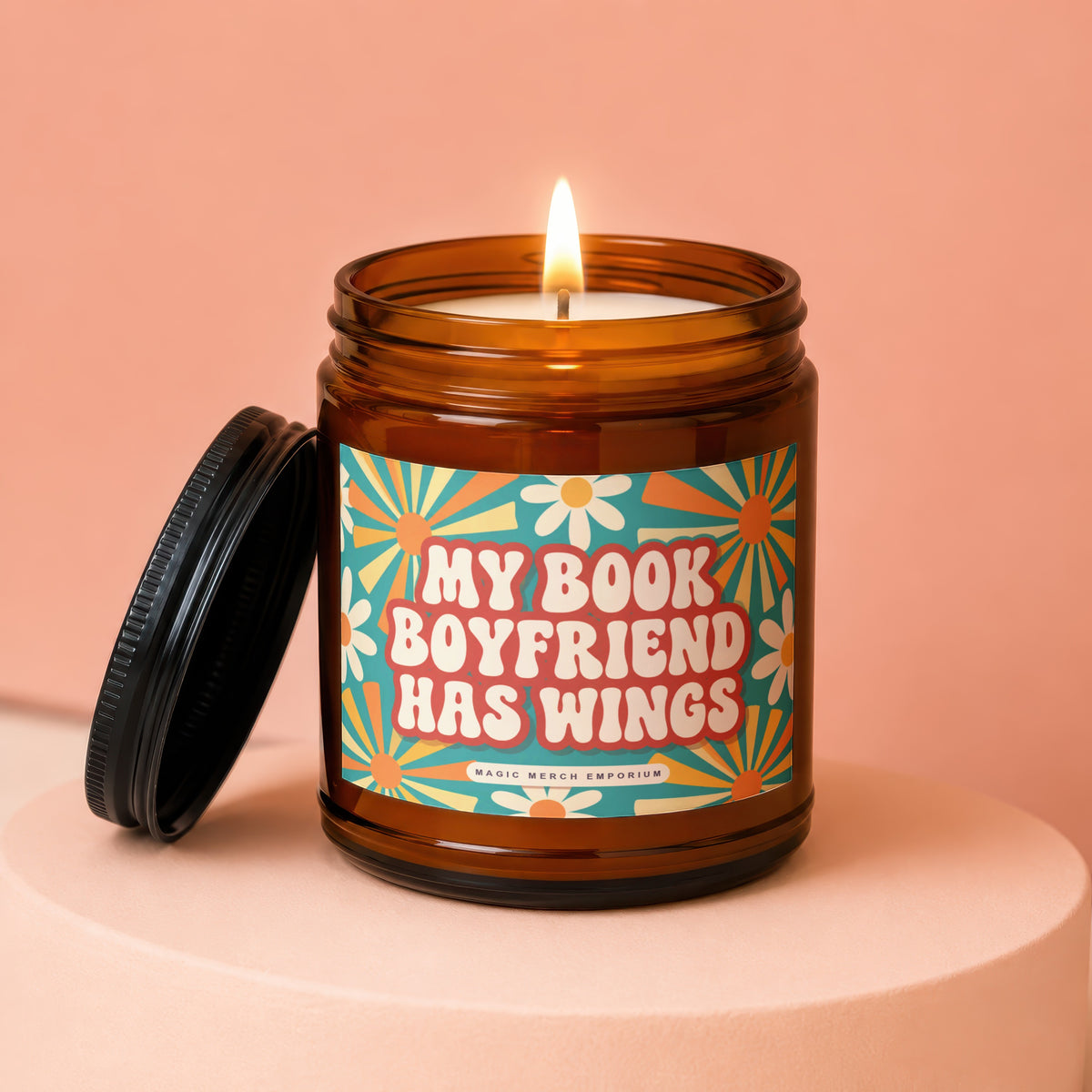 Amber jar candle with lit wick and "My Book Boyfriend Has Wings" text.