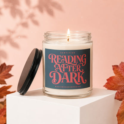 Jar candle with "Certified Reading After Dark" label on pink background with fall leaves.