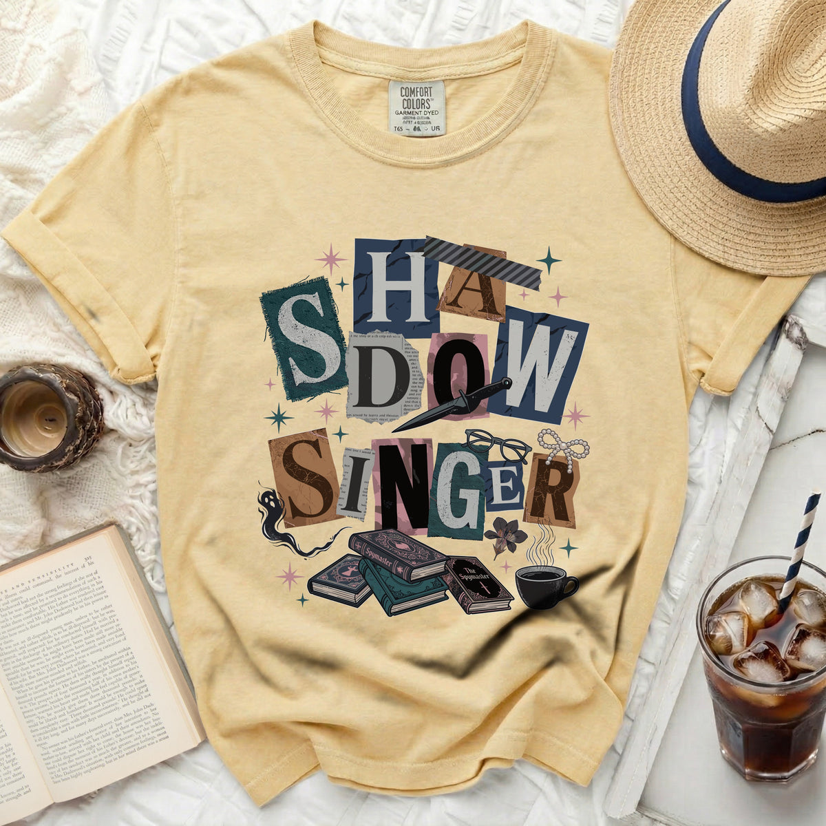 Yellow t-shirt with "Shadow Singer" graphic and book illustration.