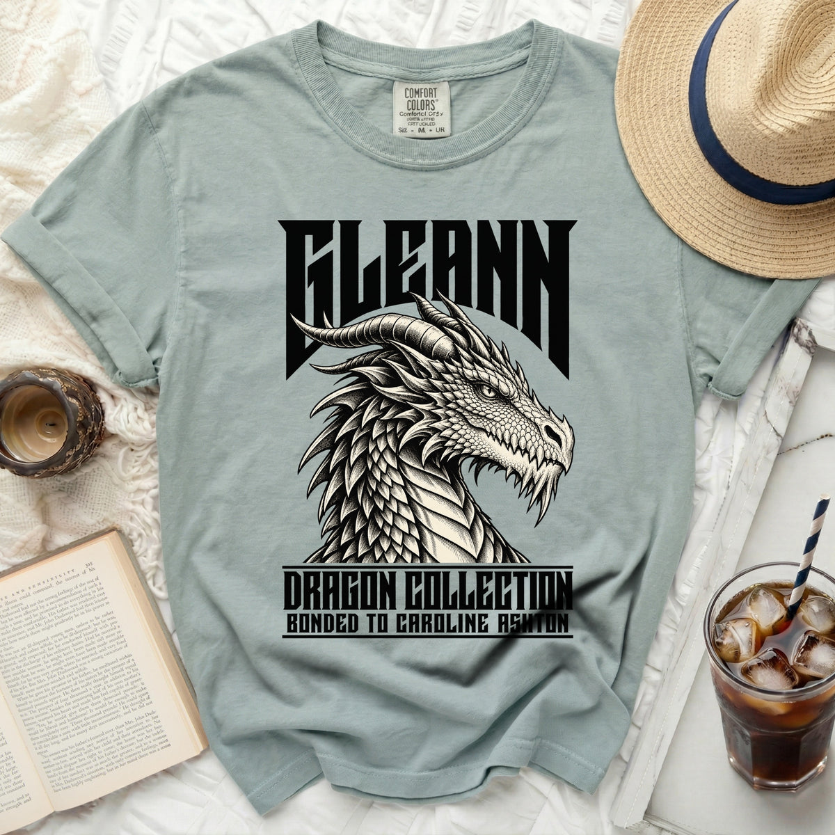 Light green t-shirt with black dragon graphic and text "FLEANN DRAGON COLLECTION BONDED TO CAROLINE ASHTON".