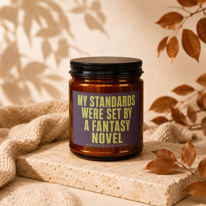 Candle with text "MY STANDARDS WERE SET BY A FANTASY NOVEL" and "MAGICMERCHEMPORIUM".
