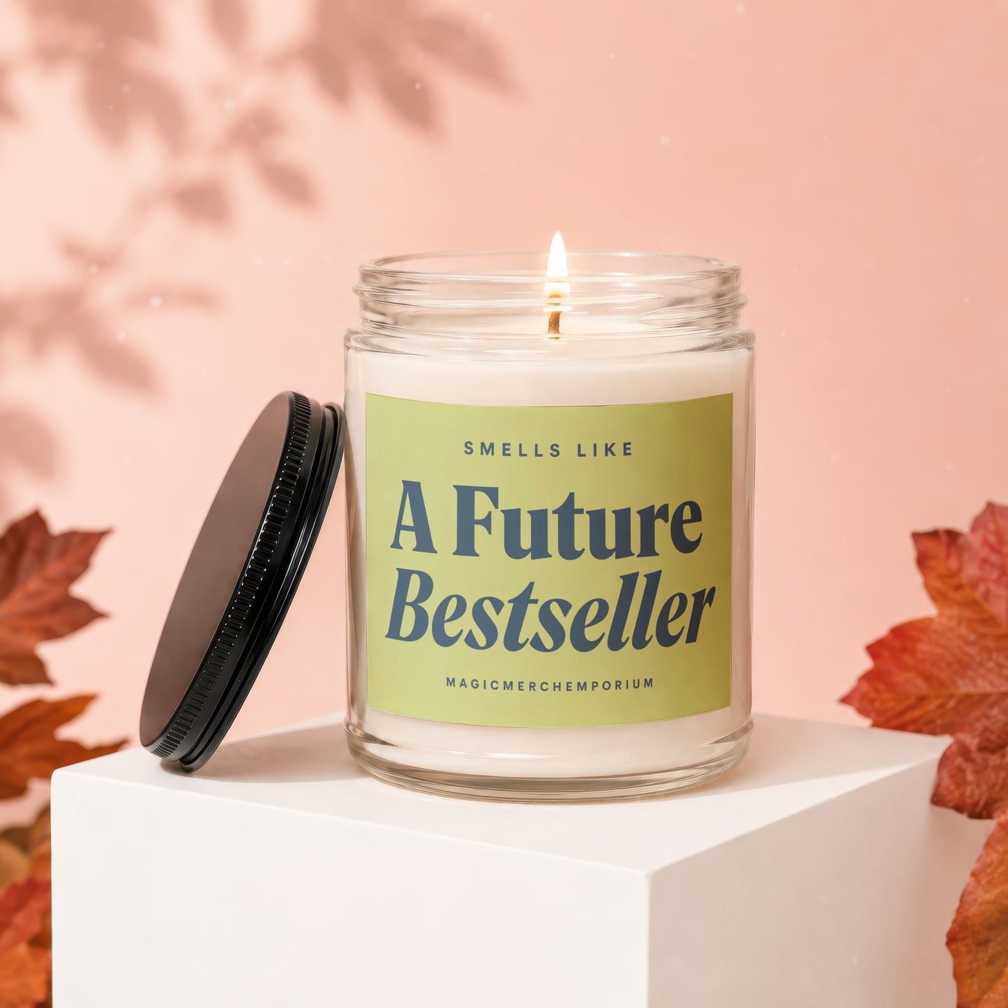 Scented candle with text "Smells Like A Future Bestseller" and "Magicmerchempirium".
