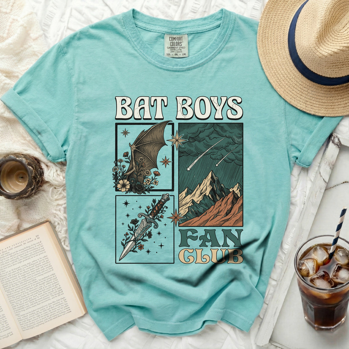 "Bat Boys Fan Club" graphic t-shirt with bat, dagger, and mountain illustrations.