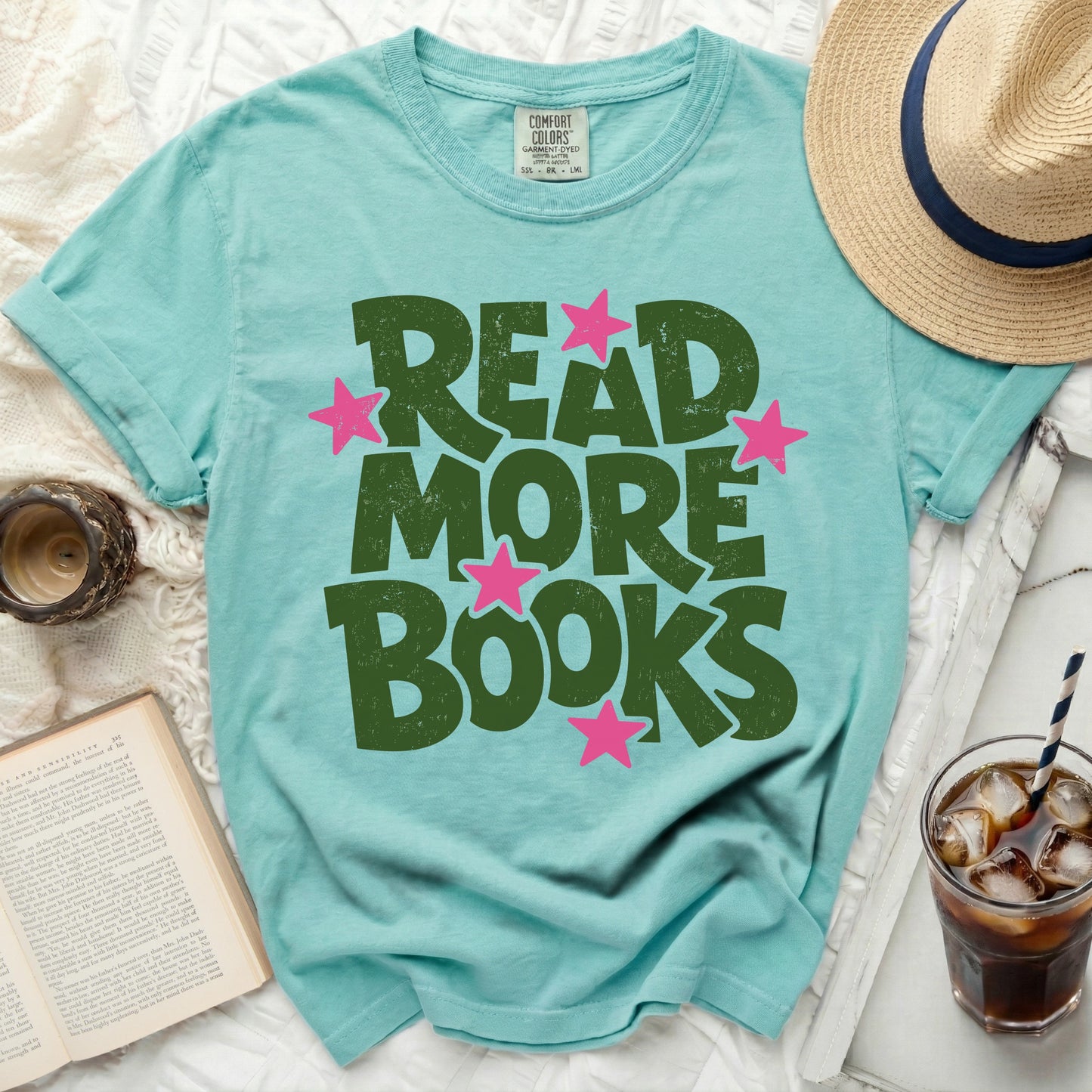 Teal t-shirt with green "Read More Books" text and pink stars.