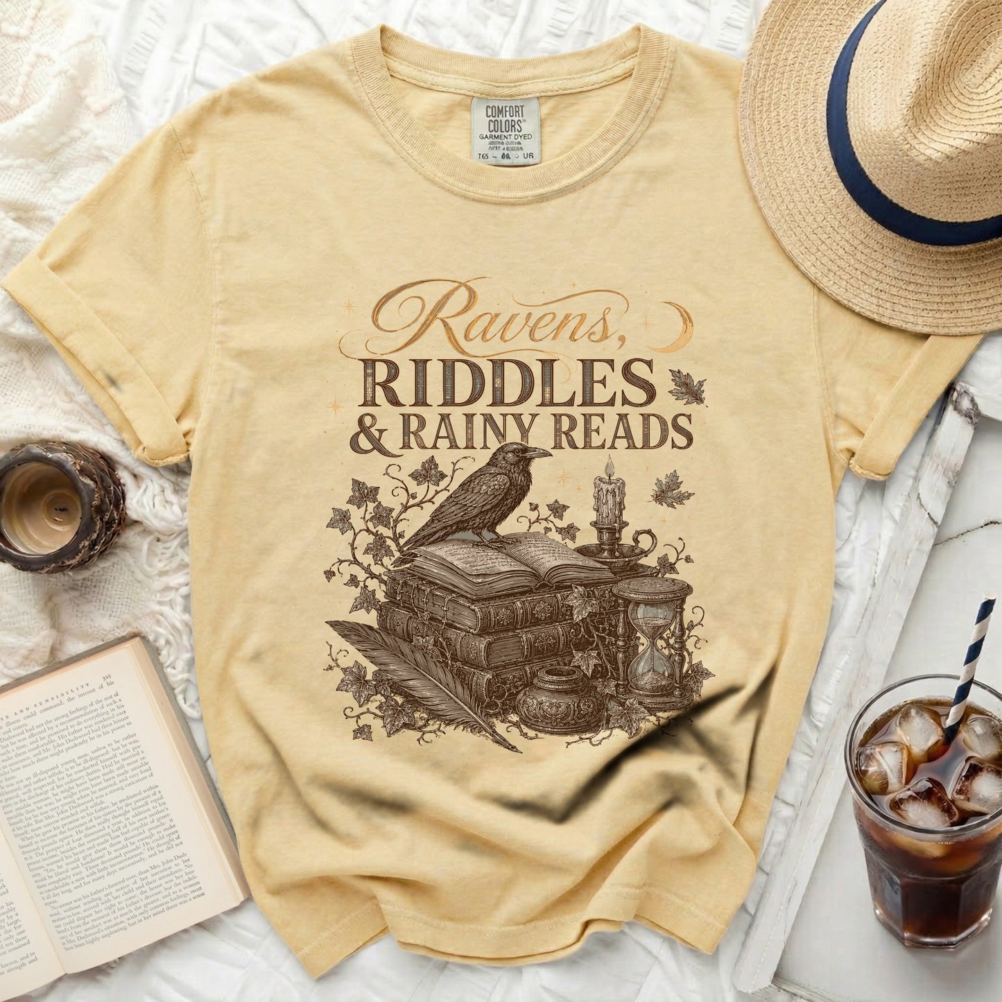 Comfort Colors yellow t-shirt with "Ravens, Riddles & Rainy Reads" graphic.