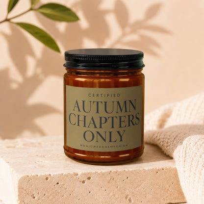 Amber candle with black lid labeled "Certified Autumn Chapters Only".