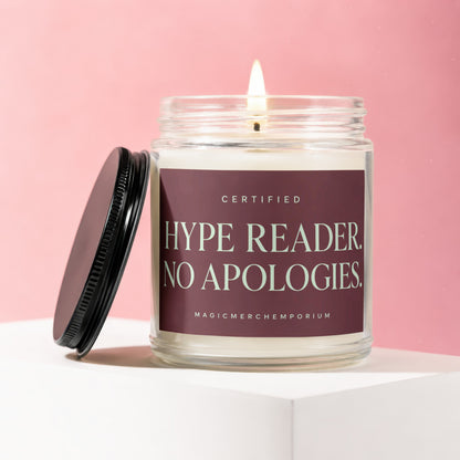Glass candle with lit wick and black lid; label reads "Certified Hype Reader. No Apologies."