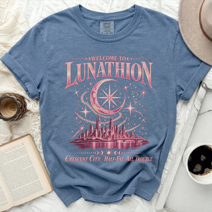 Blue t-shirt with "Welcome to Lunathion Crescent City Half-Fae, All Trouble" text and city graphic.