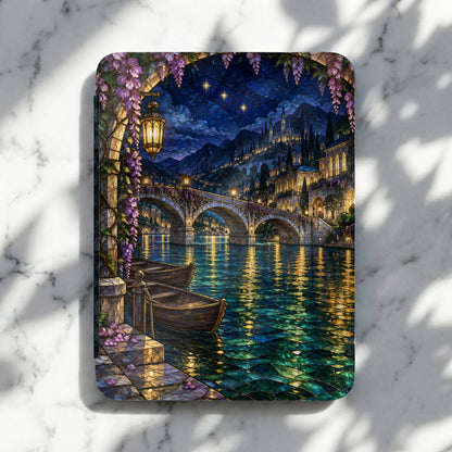 Stained glass scene of a canal at night with arched bridge and illuminated buildings.