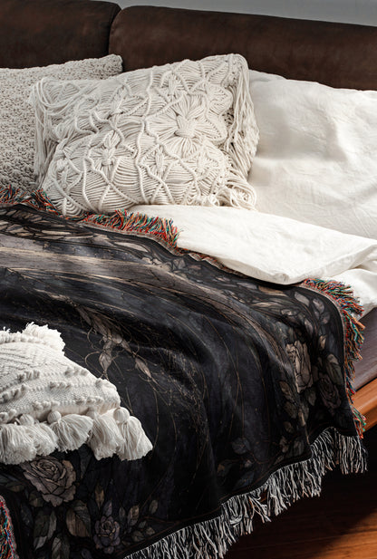 a cozy and inviting bedroom scene, featuring a bed with a black and white patterned blanket, a white pillow, and a brown leather couch.