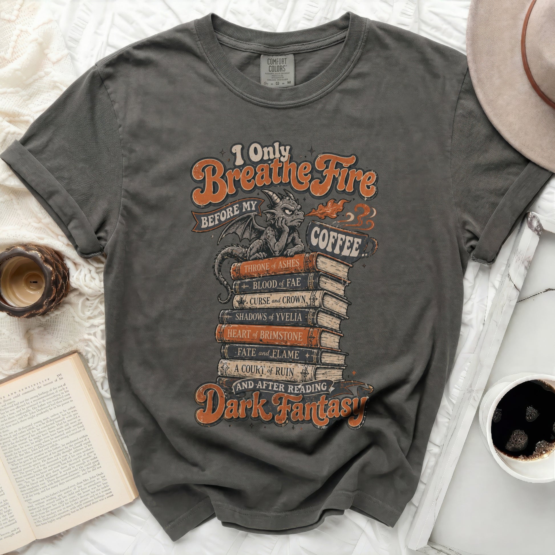Dark fantasy t-shirt with stacked books and "I Only Breathe Fire Before My Coffee" text.