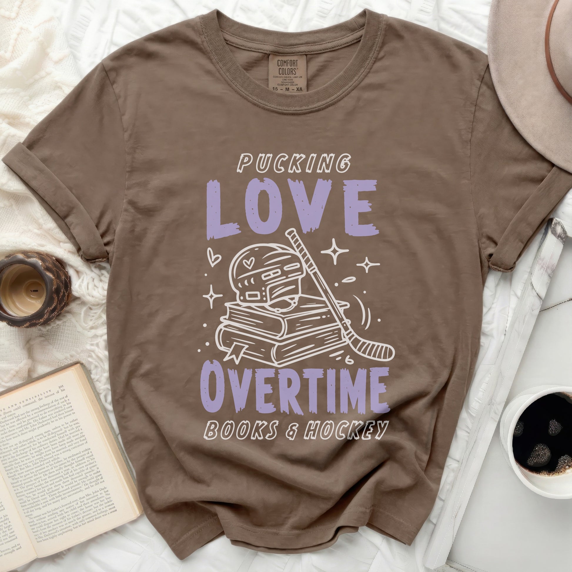 Brown t-shirt with "Pucking Love Overtime Books & Hockey" text.