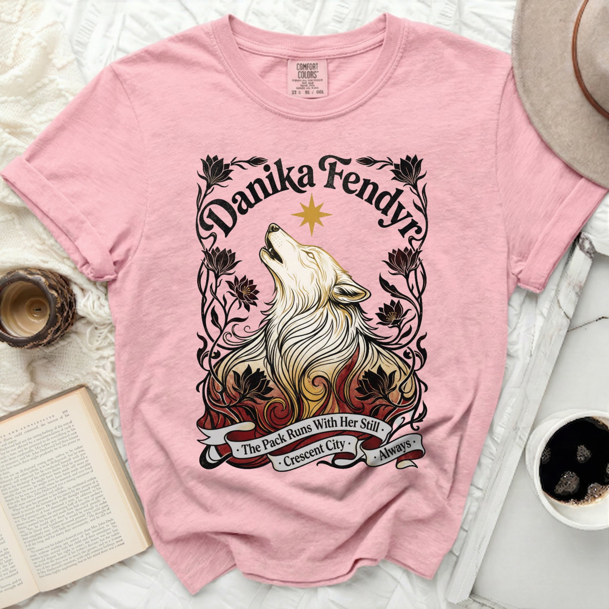 Pink t-shirt with wolf illustration and text "The Pack Runs With Her Still Crescent City Always".