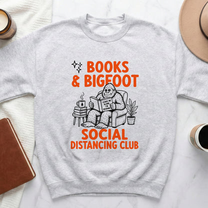 Bigfoot reading a book with text "Leave me alone. I'm reading" on a sweatshirt.