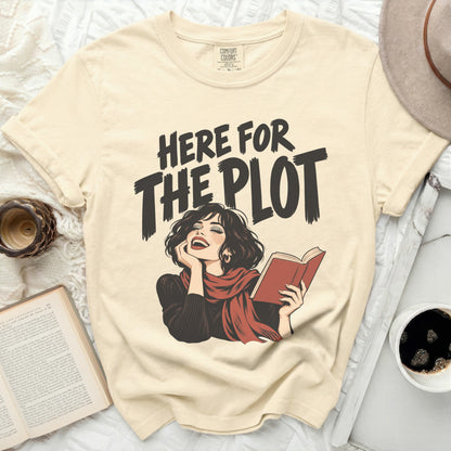 Cream t-shirt with "Here for the Plot" graphic of a woman reading.