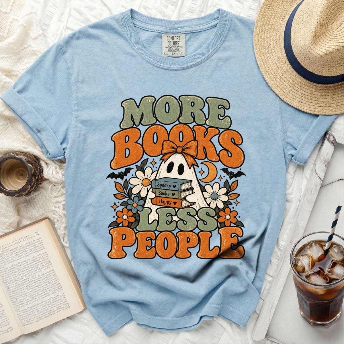 Light blue t-shirt with ghost and books graphic saying "More Books Less People".